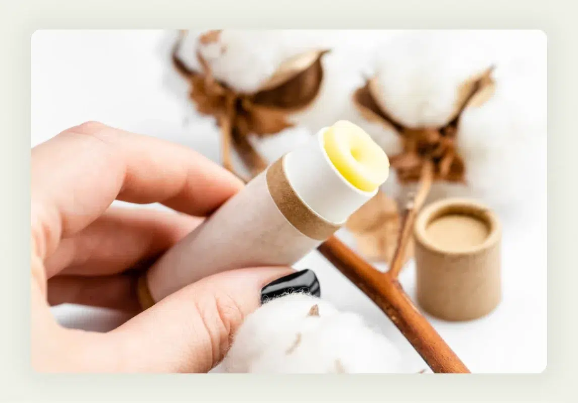 Branded lip balm tubes and hand sanitizer bottles arranged as trade show promotional items