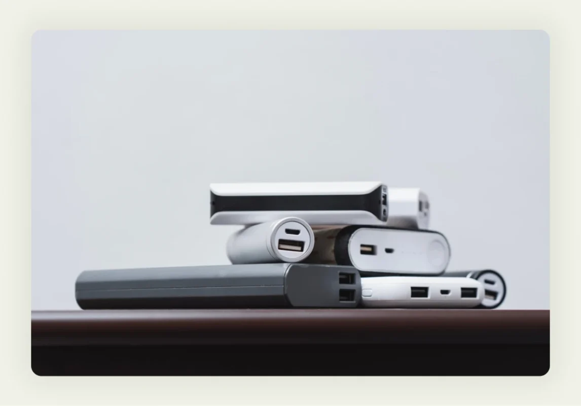 Branded portable power banks and phone chargers displayed as tech trade show giveaways