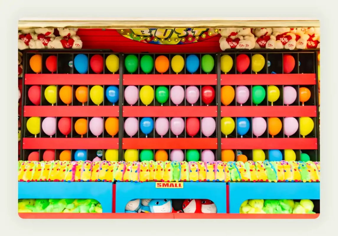 Carnival-style ring toss and basketball games set up at trade show booth