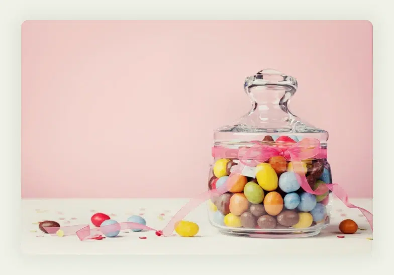 Clear jar filled with colorful items for guessing game at trade show