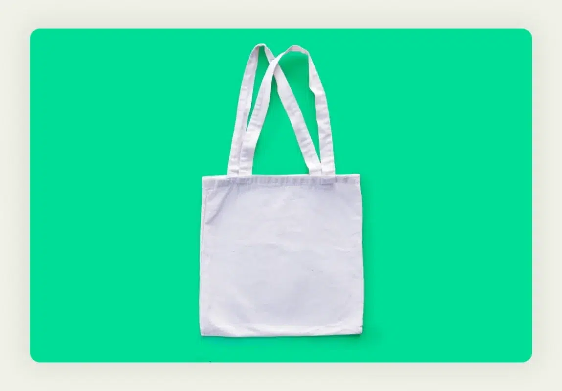 Professional branded tote bags with company logo displayed at trade show booth