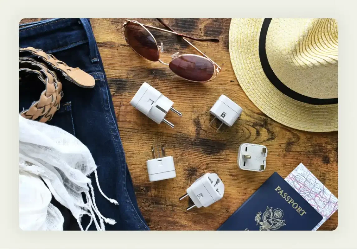Universal travel adapters with USB ports featuring company branding for business travelers